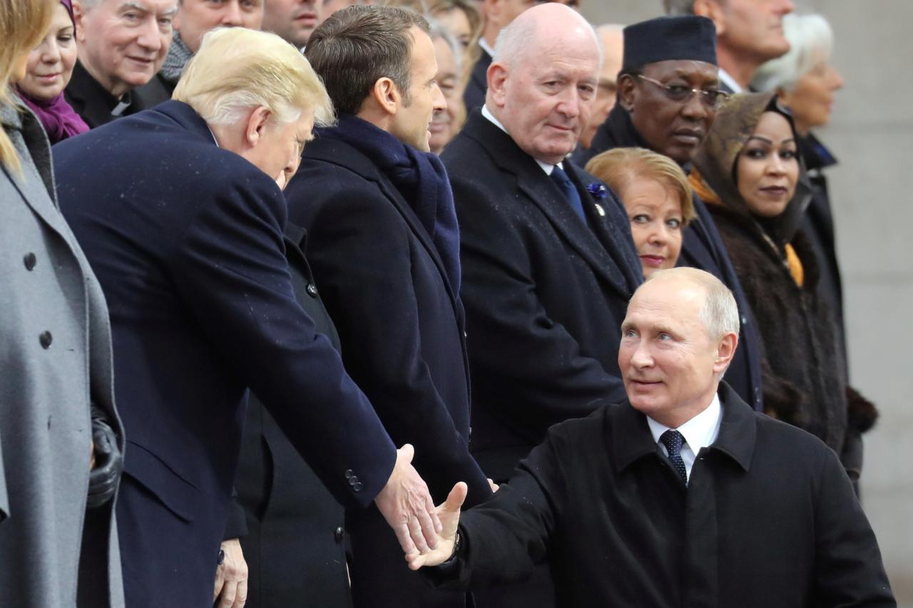 Russian President Vladimir Putin shakes hands with U.S. President Donald Trump as he arrives to attend a commemoration ceremony for Armistice Day, 100 years after the end of the First World War at the Arc de Triomphe, in Paris